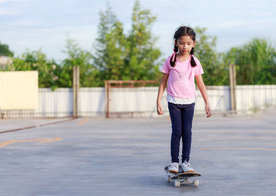 Portrait of a girl standing on road