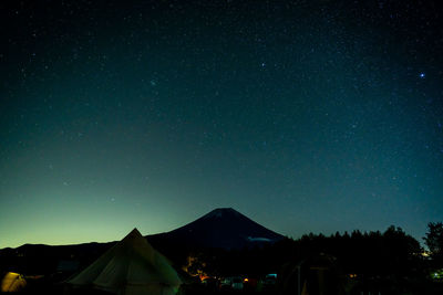 Scenic view of mountains against sky at night