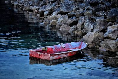 Boat on rock by water