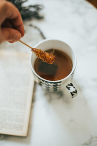 Midsection of person holding tea cup