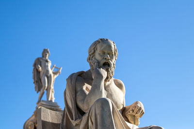 Low angle view of statue against clear blue sky