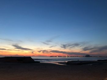 Scenic view of beach against sky during sunset