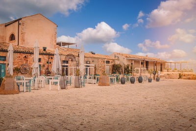 Built structures on beach against sky