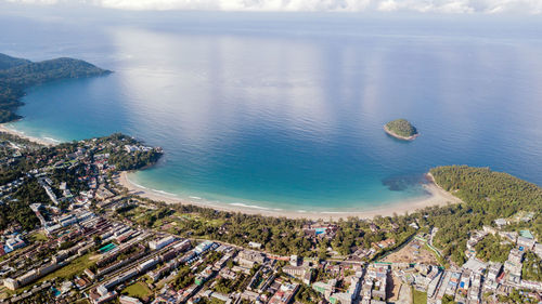 High angle view of sea and cityscape against sky