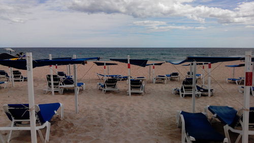 Lounge chairs and tables at beach