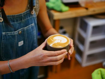 Midsection of woman using mobile phone
