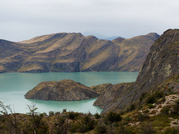 Scenic view of lake and mountains against sky