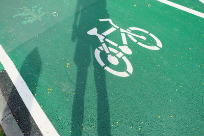 Shadow of man on bicycle lane