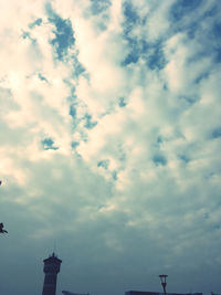 Low angle view of building against cloudy sky