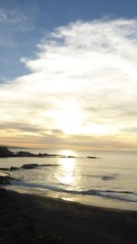 Scenic view of beach against sky during sunset