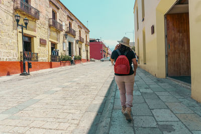 Rear view of woman walking on street