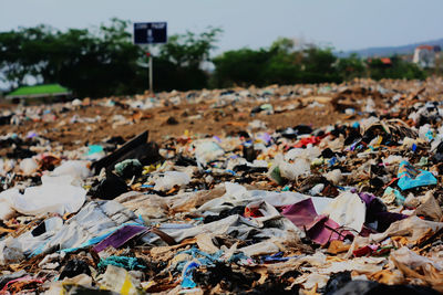 Low angle view of multi colored garbage in the land