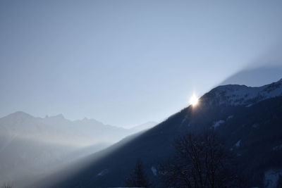 Scenic view of mountains against clear sky during winter