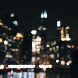 Defocused image of illuminated city at night