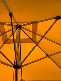 Low angle view of metallic structure against sky during sunset