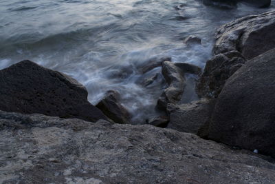 High angle view of water flowing on rocks