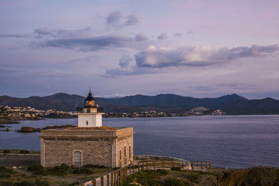 View of building by sea against sky