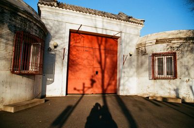 Shadow of people on street against building