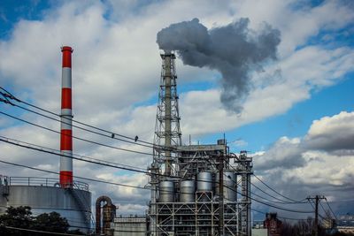 Low angle view of smoke stack against sky