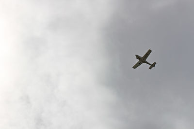 Low angle view of airplane flying in sky