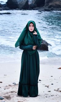 Full length of woman standing at beach