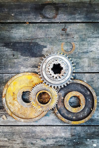 Directly above view of rusty metallic gears on table