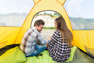 Young couple sitting in tent