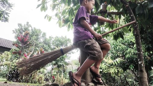 Side view of woman against trees