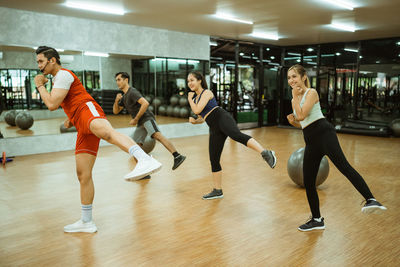 Side view of woman exercising in gym