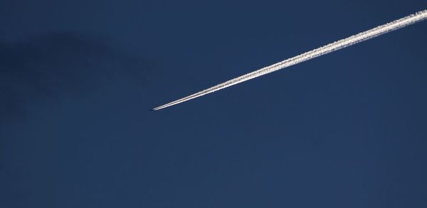 Low angle view of airplane flying in sky