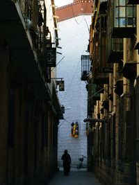 Rear view of people walking on street in city