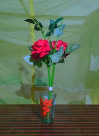 Close-up of red flower vase on table