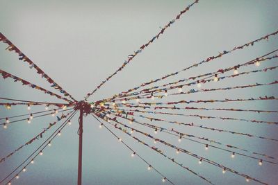 Low angle view of decorations against cloudy sky