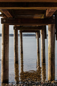 Silhouette of pier on beach