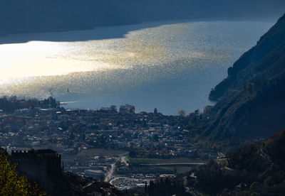 High angle view of buildings and sea against sky at sunset