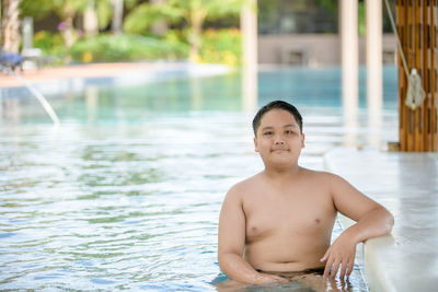 Portrait of shirtless boy in swimming pool