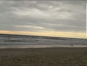 Scenic view of beach against sky during sunset