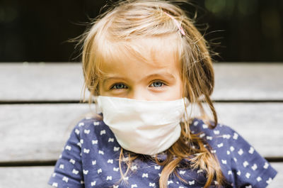 Close-up portrait of girl wearing mask