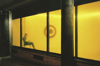 Side view of women seen through yellow window