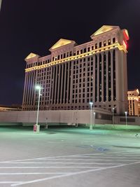 Low angle view of illuminated building against sky at night