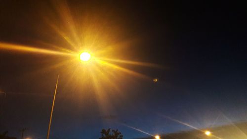 Low angle view of vapor trail against sky during sunset