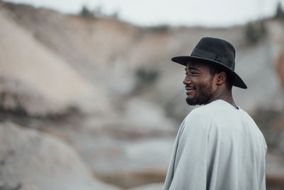 Portrait of man wearing hat standing outdoors