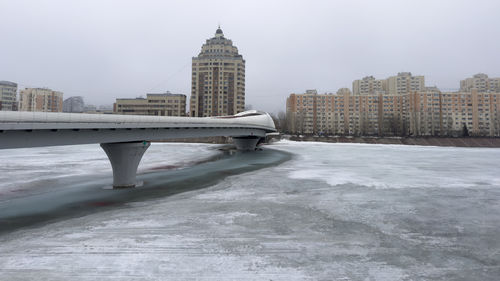 Atyrau pedestrian bridge across the frozen ishim river in astana, kazakhstan april 2, 2024.