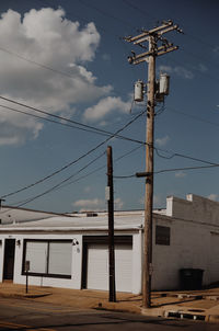 Low angle view of electricity pylon against sky