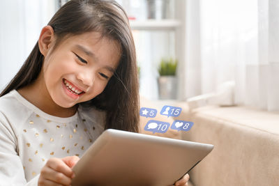 Smiling girl using mobile phone