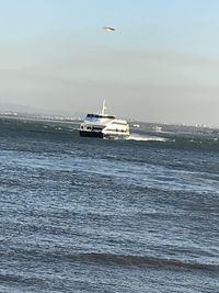 Ship sailing on sea against sky