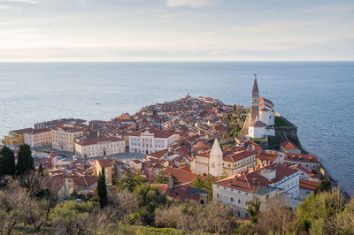 High angle view of townscape by sea