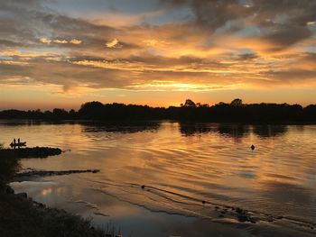 Scenic view of lake against sky during sunset
