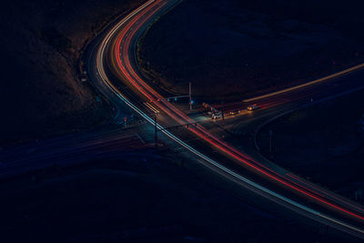 High angle view of light trails on road at night