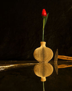 Close-up of red bell against black background
